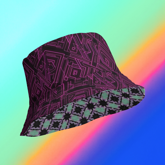 Dual Dimension reversible bucket hat hero flat lay — mint teal lavender geometric tile print side A and deep plum neon magenta circuit maze print side B on pink to purple gradient background