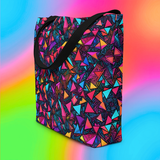 Prism Riot large tote bag hero product shot — black base with neon pink orange teal purple and yellow scattered triangle all-over print three-quarter angle on rainbow gradient background
