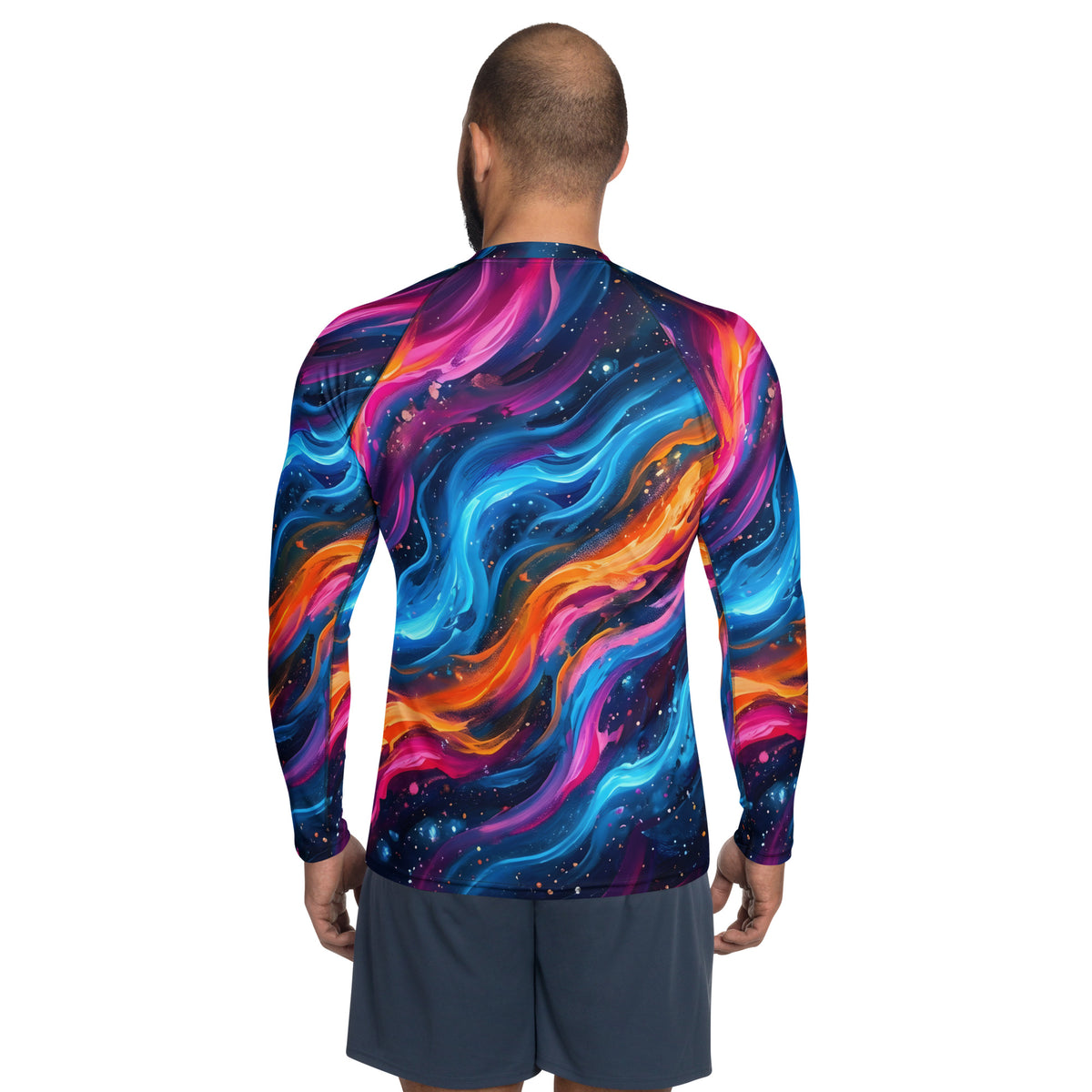 Back view of male model wearing the Cosmic Surge men's rash guard showing the full cosmic wave all-over print in neon blue, magenta, and orange wrapping around the back and sleeves