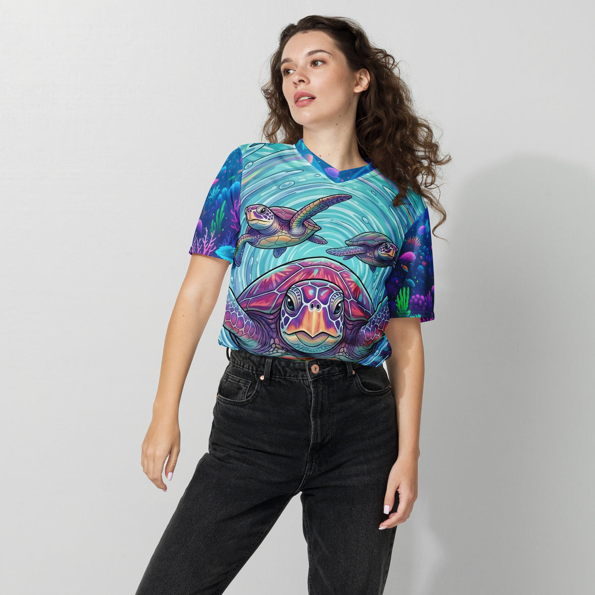 Female model wearing the Tidal Drift Turtles unisex sports jersey with a vibrant sea turtle all-over print in teal, purple, and pink