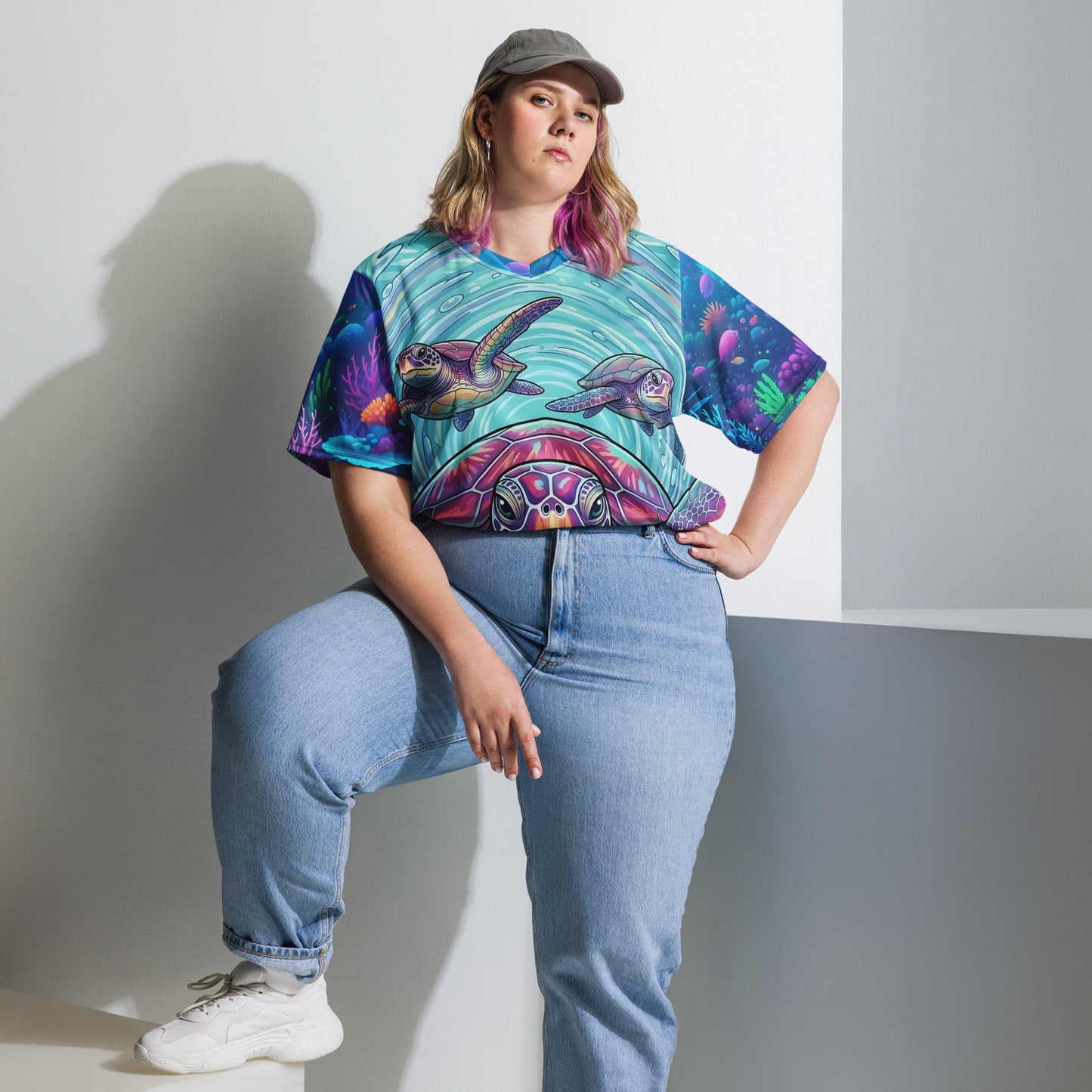Female plus-size model wearing the Tidal Drift Turtles all-over print sports jersey showing the neon sea turtle front design with coral reef sleeves