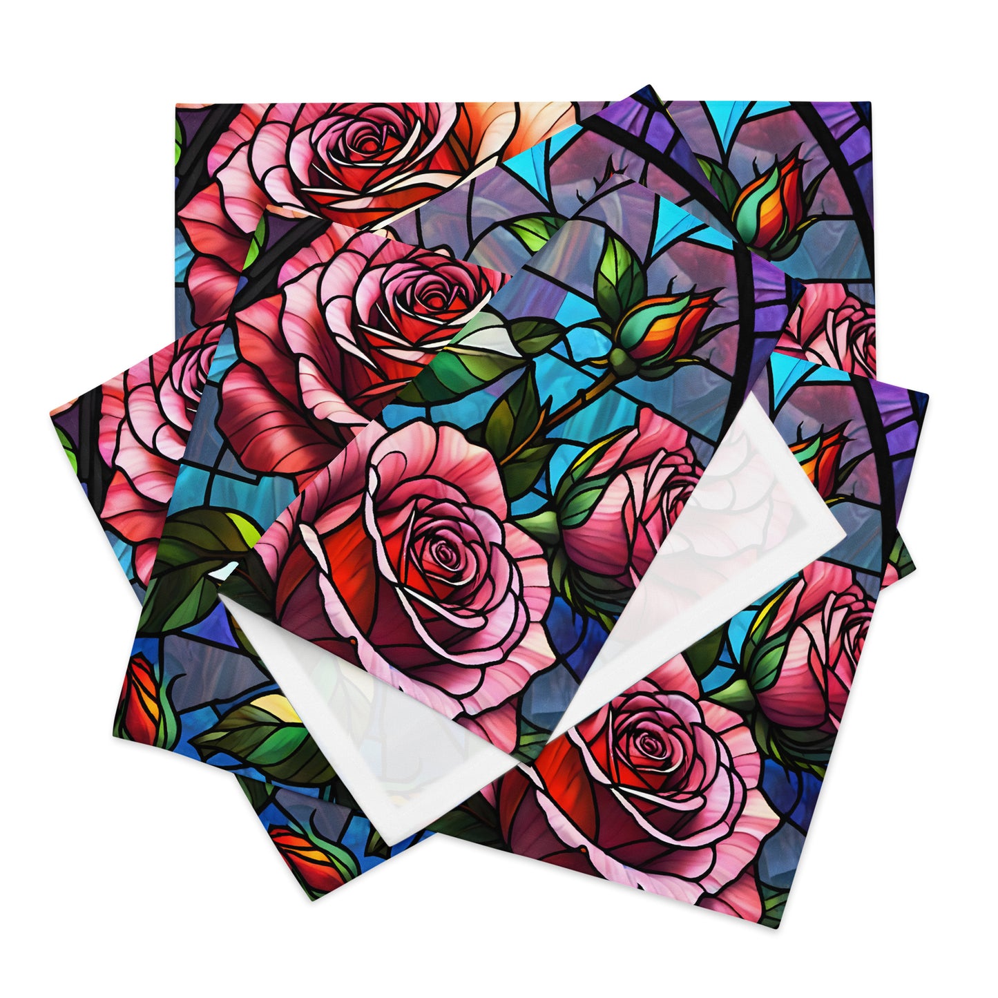 Stained Roses Placemat Set product shot — set of four placemats fanned out in a stack showing stained glass mosaic design of large pink and red roses with green leaves and colorful geometric background panels in blue purple and teal with white reverse side visible on white background