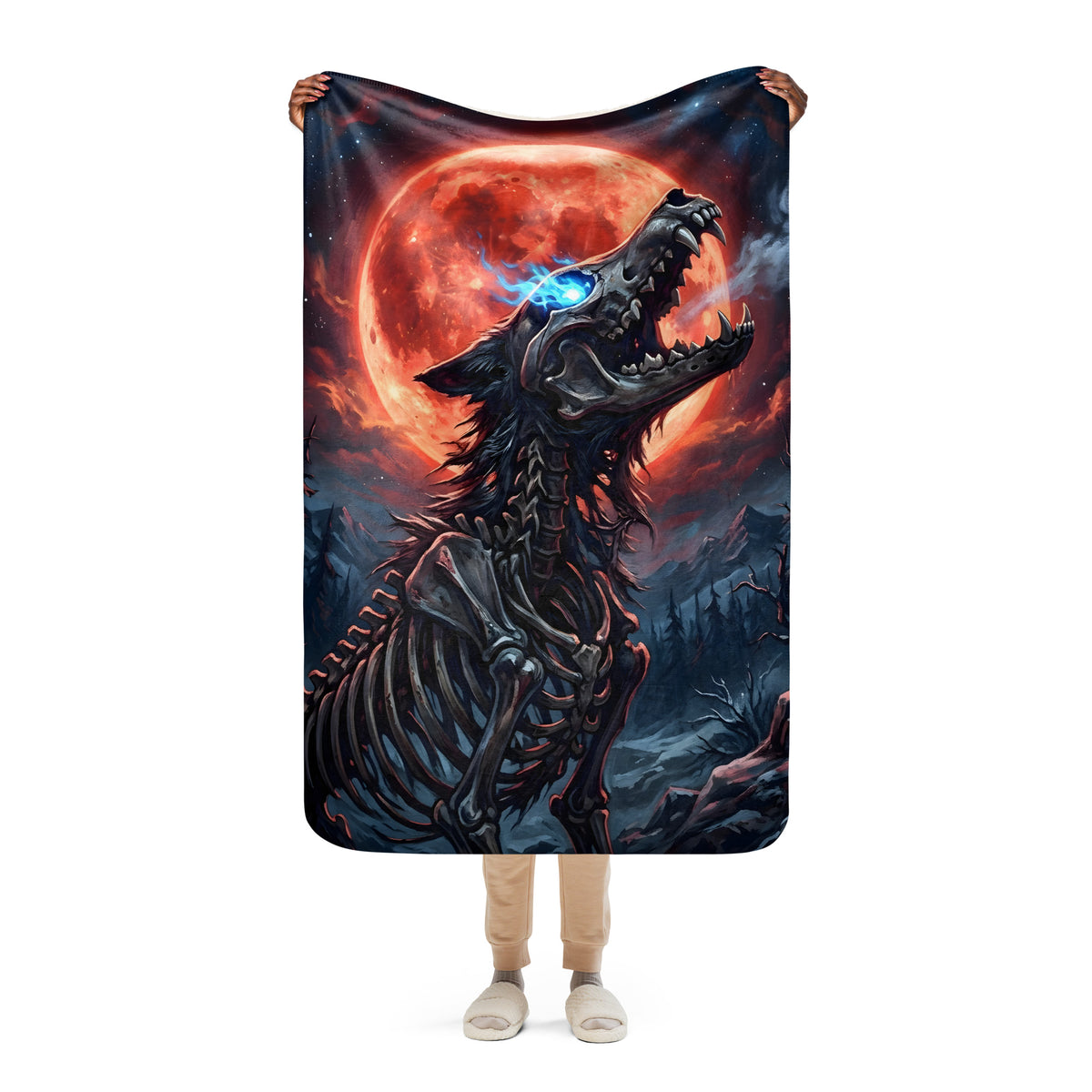 Person holding the 37 × 57-inch Blood Moon Bonewolf blanket upright, showing the skeletal wolf, glowing blue eye, and red moon artwork.