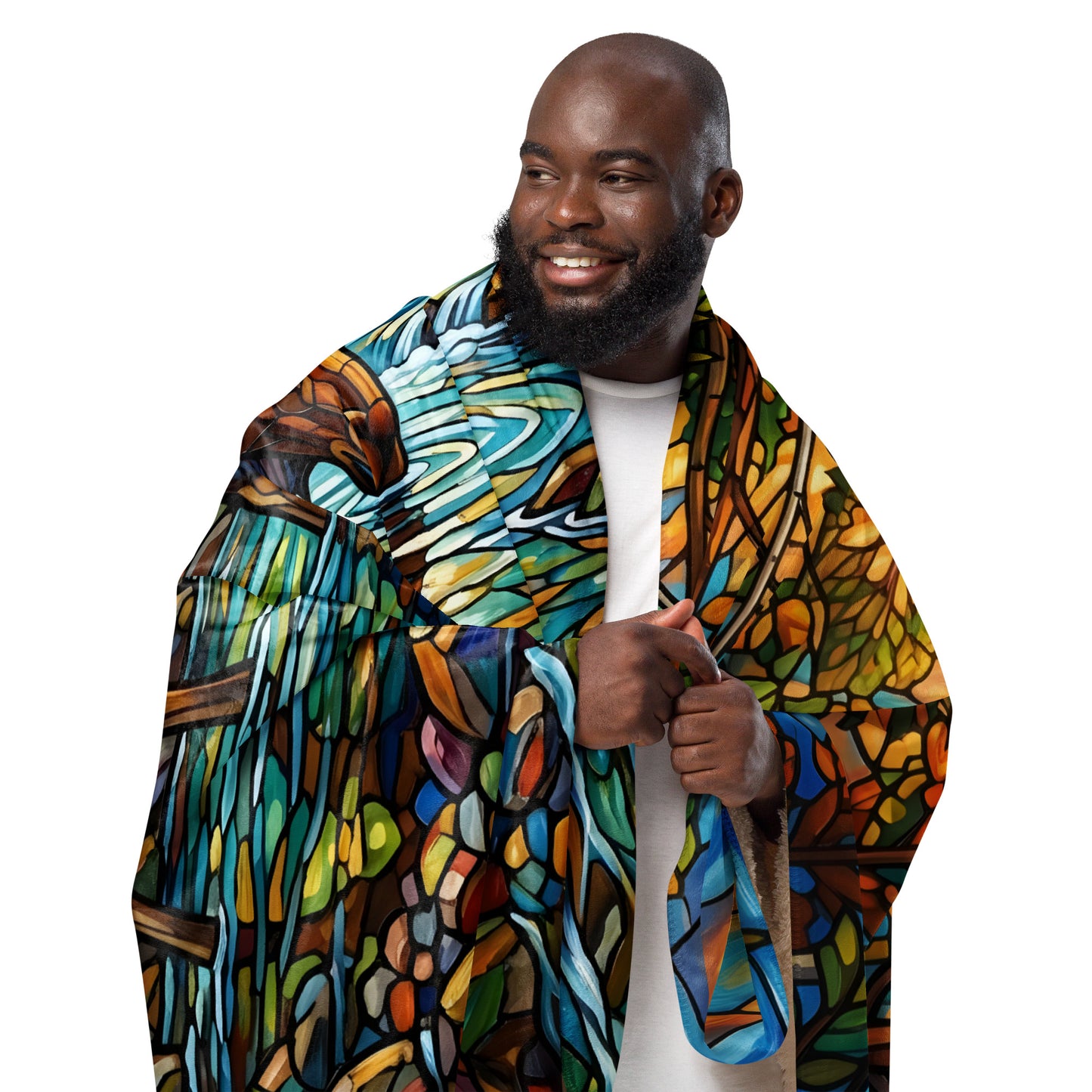 Mosaic Moose Sherpa Blanket lifestyle shot — smiling Black male model wearing 50x60 blanket draped over shoulders showing stained glass mosaic moose forest stream graphic with cream sherpa interior visible on white background