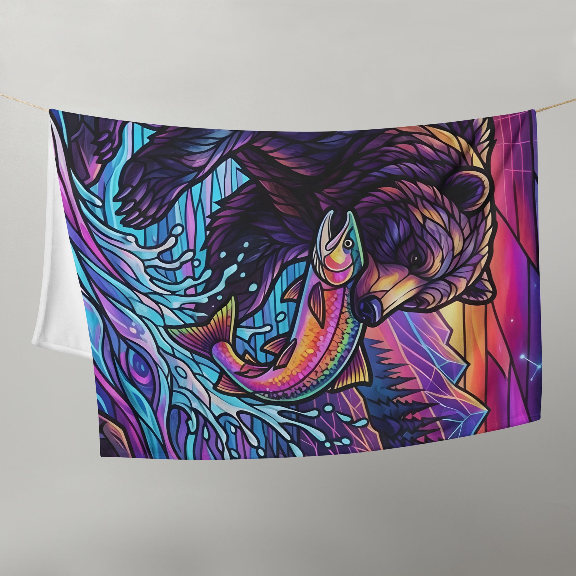 Stained Glass Grizzly Bear Throw Blanket 50x60 hung on line — close-up showing grizzly bear catching rainbow trout in neon teal river with stained glass linework and white fleece reverse on grey background