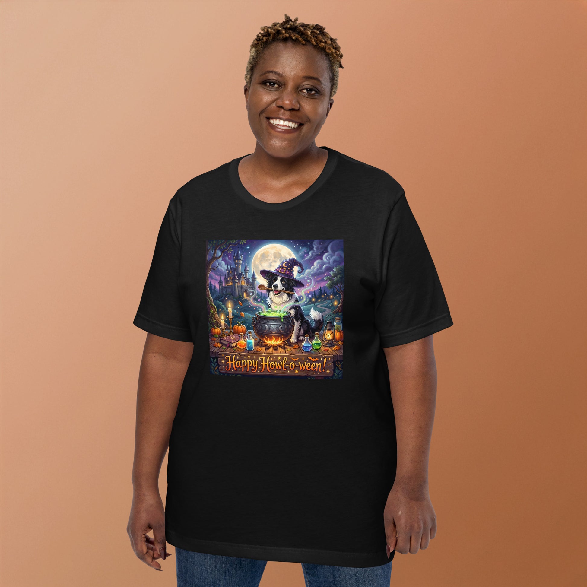 Scout- Happy Howl-o-ween! Unisex T-Shirt lifestyle shot — smiling plus-size Black female model wearing black tee showing front graphic of border collie Scout in witch hat stirring glowing green cauldron with pumpkins potions and haunted castle under full moon and "Happy Howl-o-ween!" text on peach background