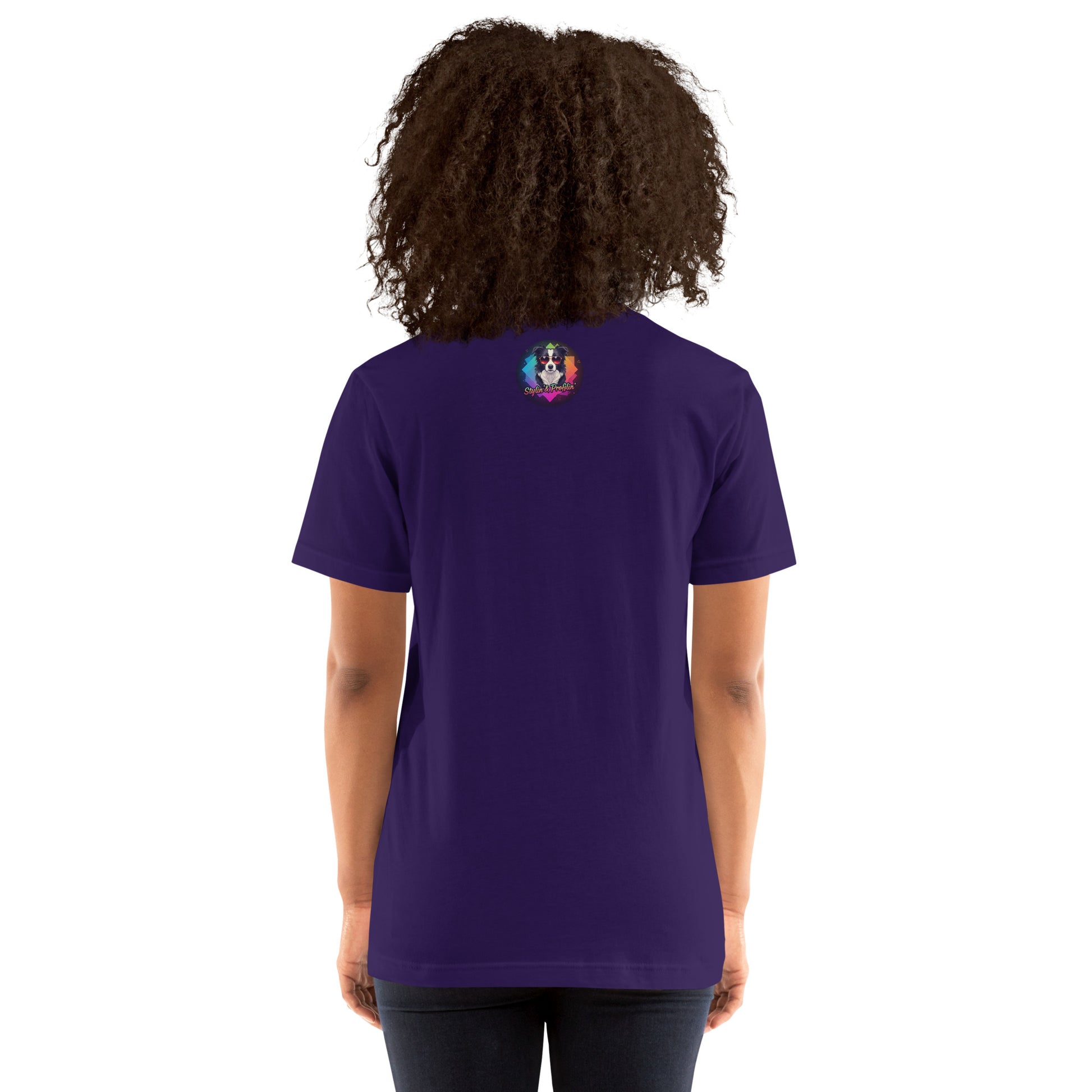 Scout- Happy Howl-o-ween! Unisex T-Shirt lifestyle shot — back view of curly-haired Black female model wearing team purple tee showing Stylin' & Profilin' border collie logo badge at upper back on white background